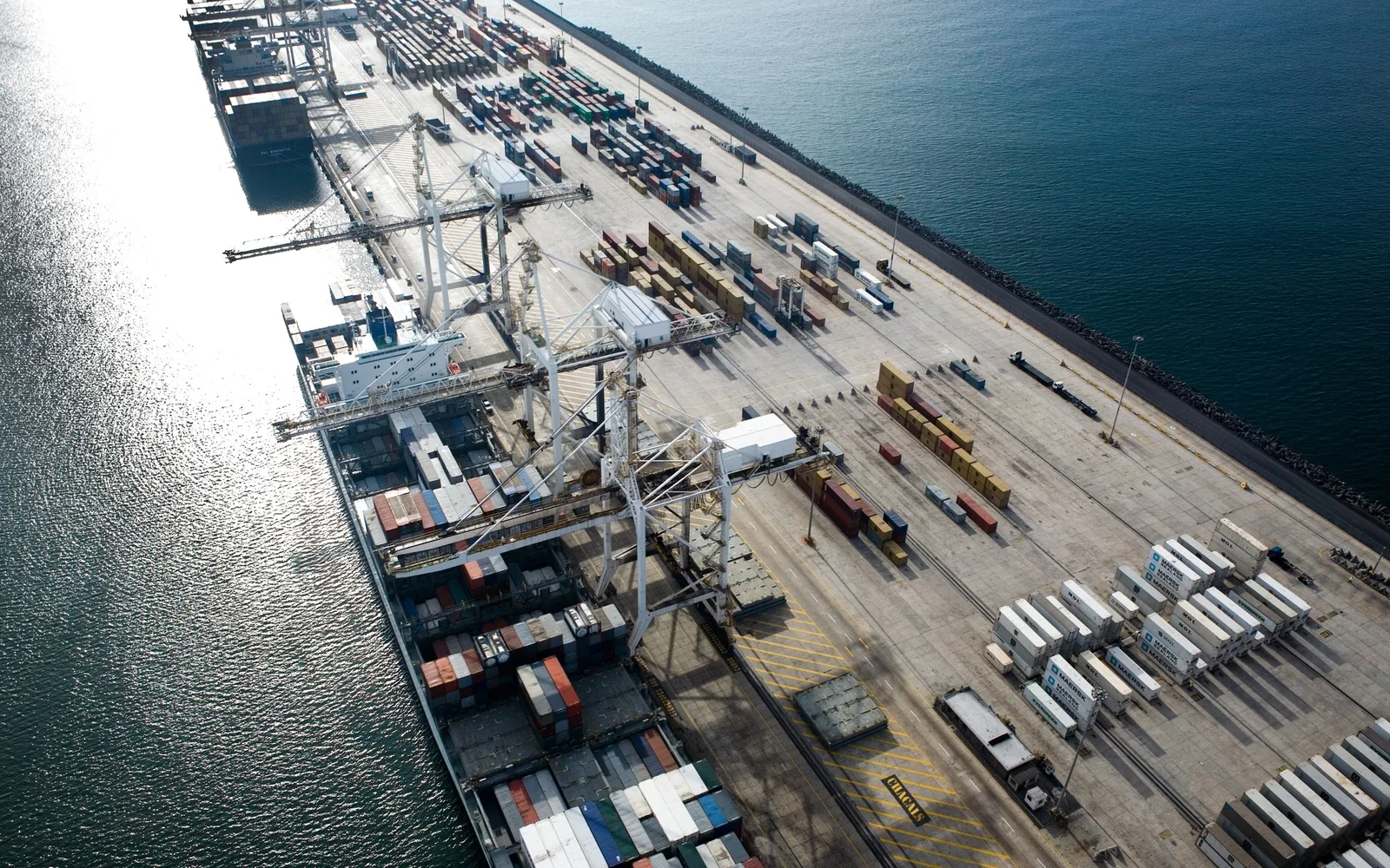 Aerial view of stacked shipping containers at a port terminal